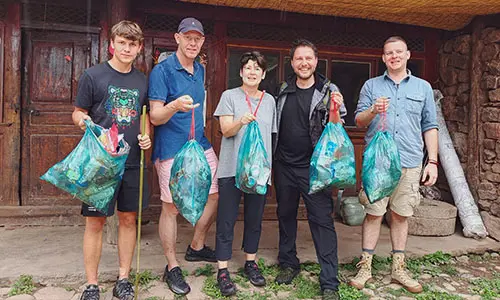 A family with teenage kid helping to protect nature in Lijiang, Yunnan, China.